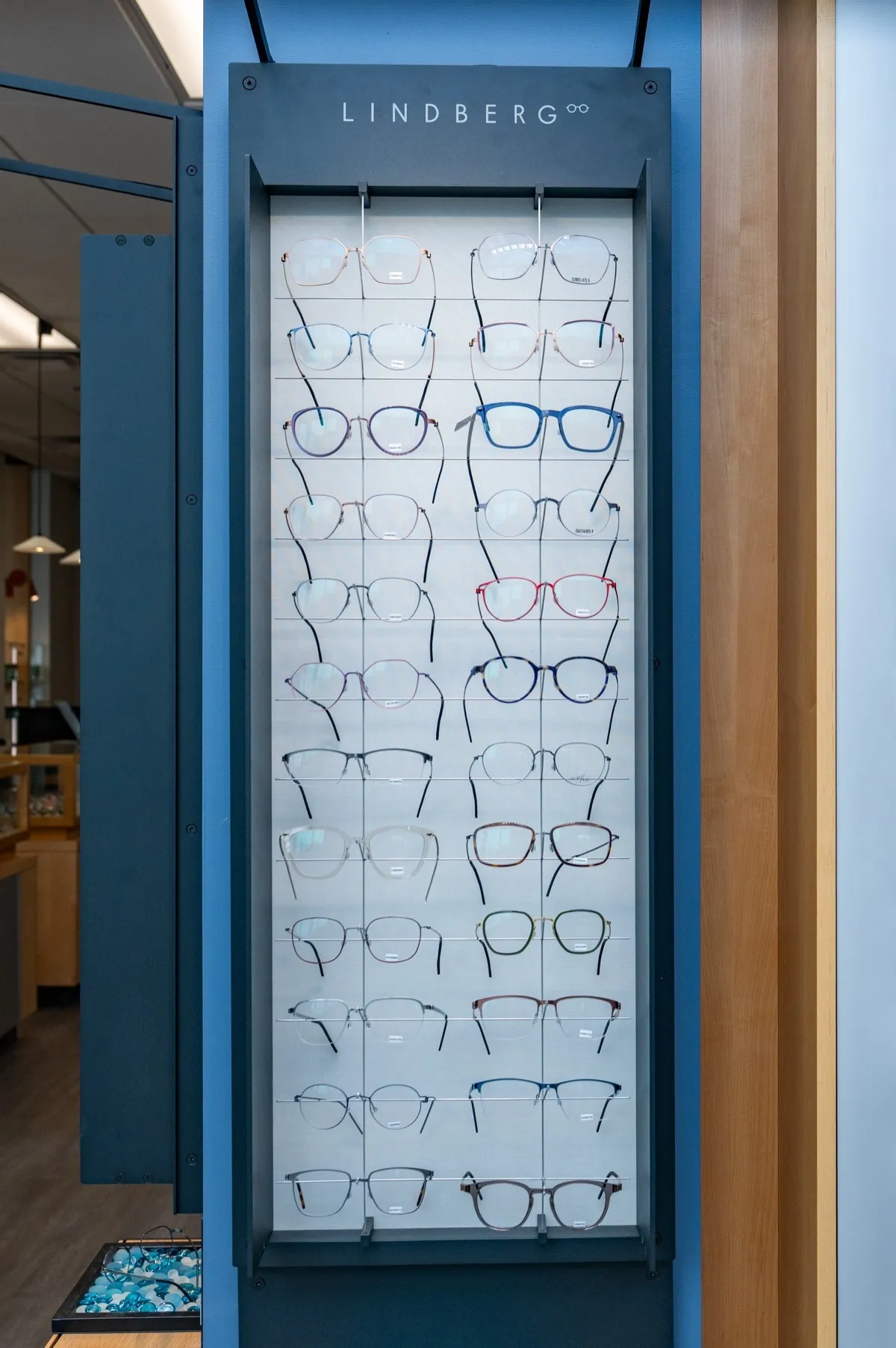 A tall Lindberg-branded frame display panel in the Voorthuis store