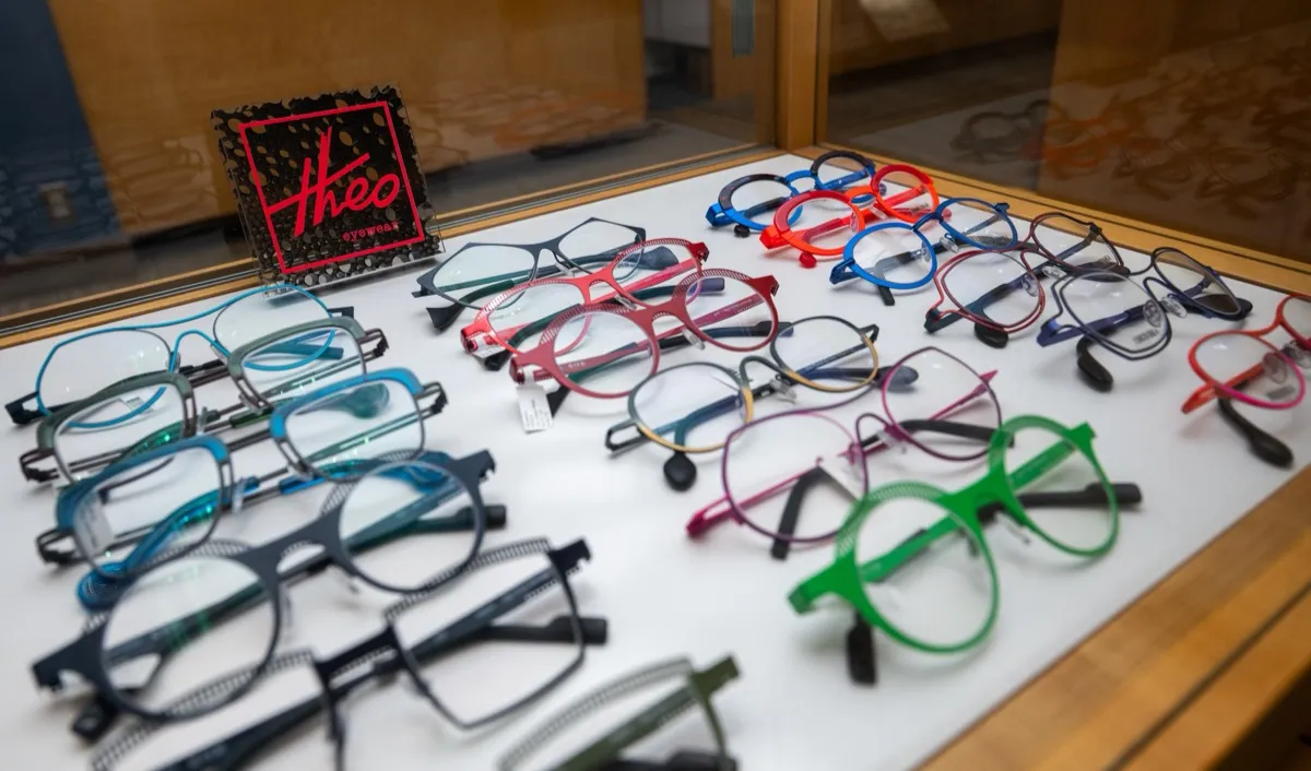 A Theo-branded display case of colorful frames at Voorthuis