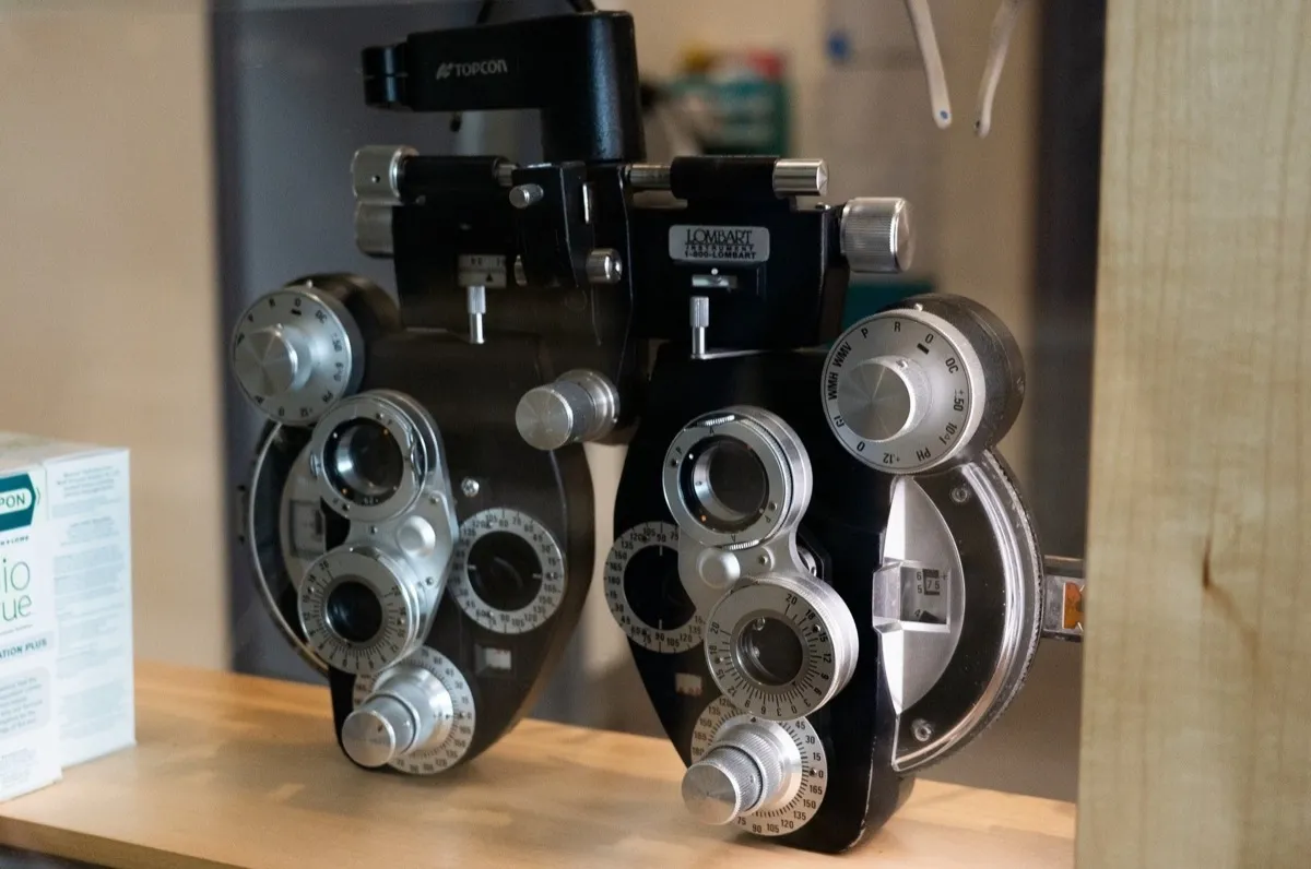 Two phoropters on display in a Voorthuis exam-room cabinet